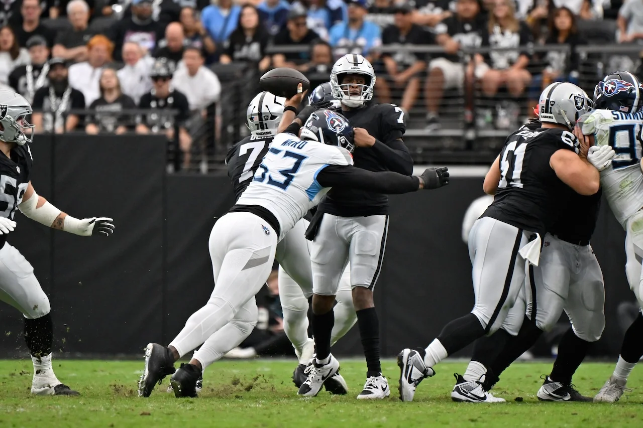 Las Vegas Raiders quarterback Geno Smith (7) throws an incomplete pass pressured by Tennessee Titans linebacker Jihad Ward (53) during the first half of an NFL football game, Sunday, Oct. 12, 2025, in Las Vegas. (AP Photo/David Becker)