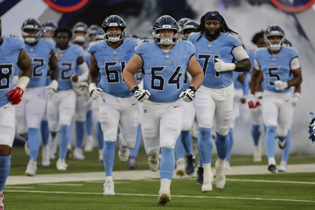 Tennessee Titans guard Jackson Slater (64) leads the team onto the field during introductions of an NFL football preseason game against the Minnesota Vikings, Aug. 22, 2025, in Nashville, Tenn. (AP Photo/Stew Milne)