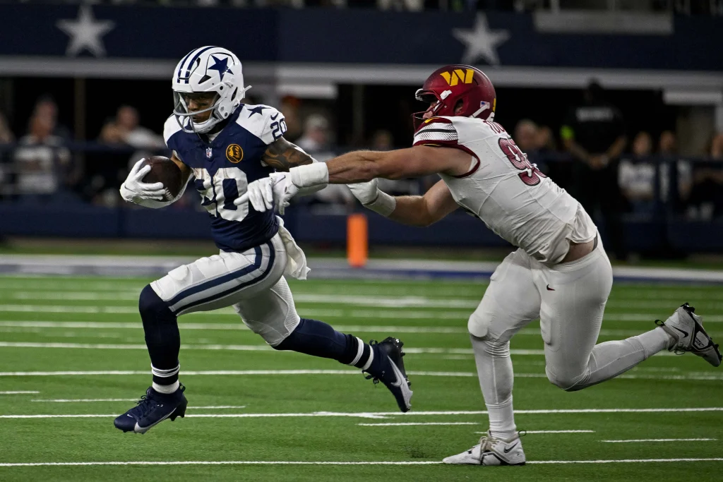 Nov 23, 2023; Arlington, Texas, USA; Dallas Cowboys running back Tony Pollard (20) and Washington Commanders defensive end Casey Toohill (95) in action during the game between the Dallas Cowboys and the Washington Commanders at AT&T Stadium. Mandatory Credit: Jerome Miron-USA TODAY Sports