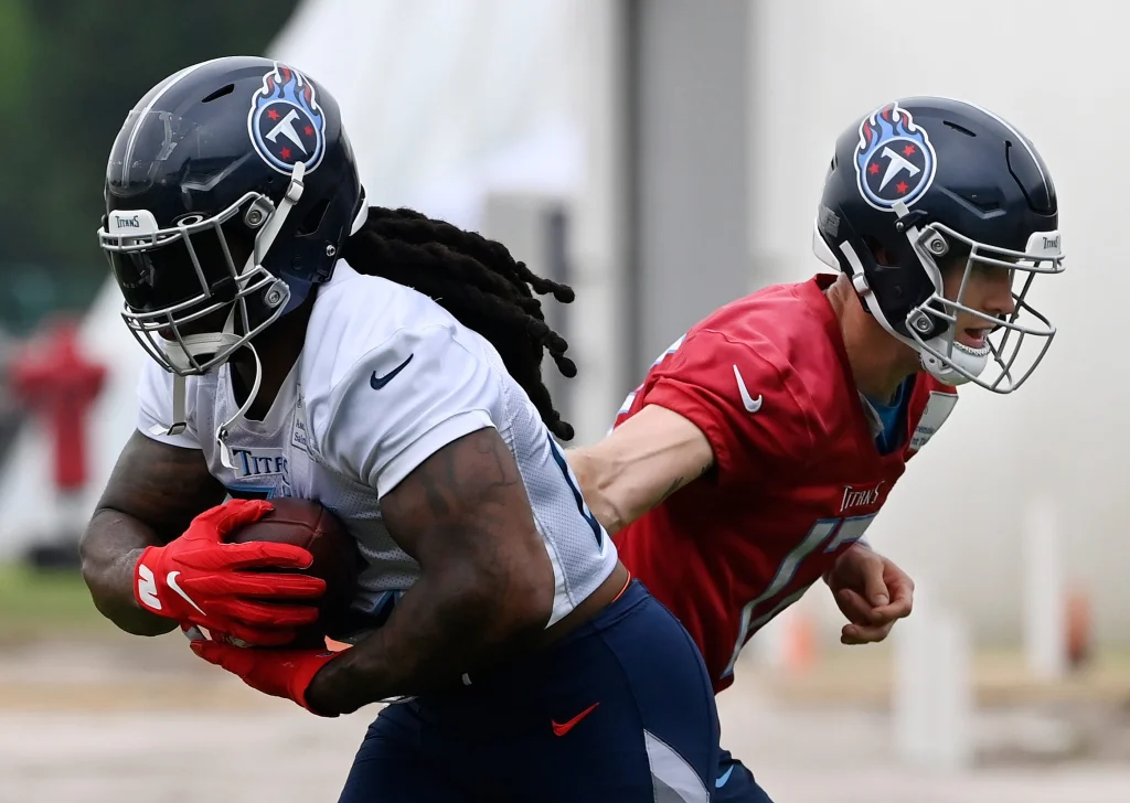 Tennessee Titans quarterback Ryan Tannehill (17) hands the ball off to running back Derrick Henry (22) during an NFL football minicamp Wednesday, June 7, 2023, in Nashville, Tenn.