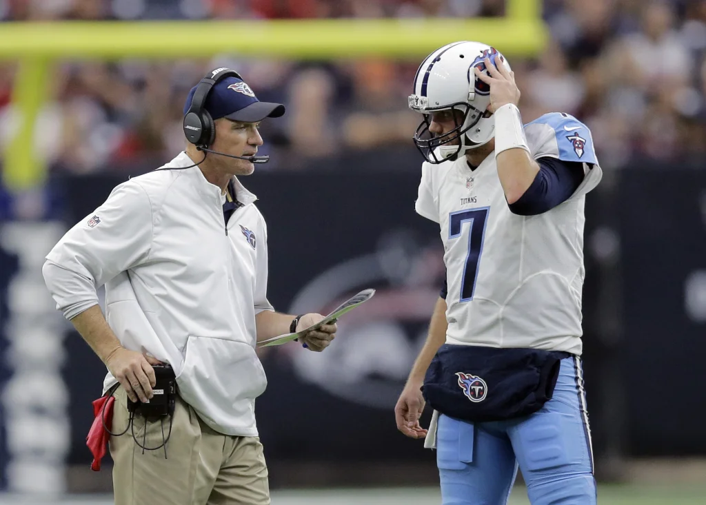 Tennessee Titans head coach Ken Whisenhunt, left, talks with quarterback Zach Mettenberger (7) during the first half of an NFL football game against the Houston Texans, Sunday, Nov. 1, 2015, in Houston. (AP Photo/Patric Schneider)