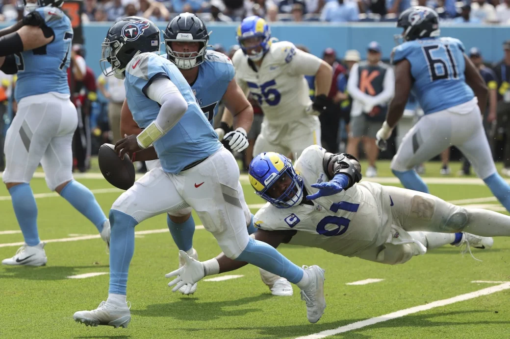 Tennessee Titans quarterback Cam Ward (1) is pressured by Los Angeles Rams defensive end Kobie Turner (91) during an NFL football game Sunday, Sept. 14, 2025, in Nashville. (Photo by Jeff Haynes/AP Images for Panini)