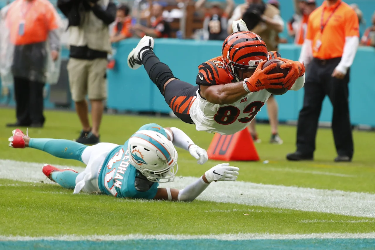 Cincinnati Bengals wide receiver Tyler Boyd (83) stretched for a touchdown as Miami Dolphins defensive back Nik Needham (40) is unable to defend, during the second half at an NFL football game, Sunday, Dec. 22, 2019, in Miami Gardens, Fla. (AP Photo/Wilfredo Lee)