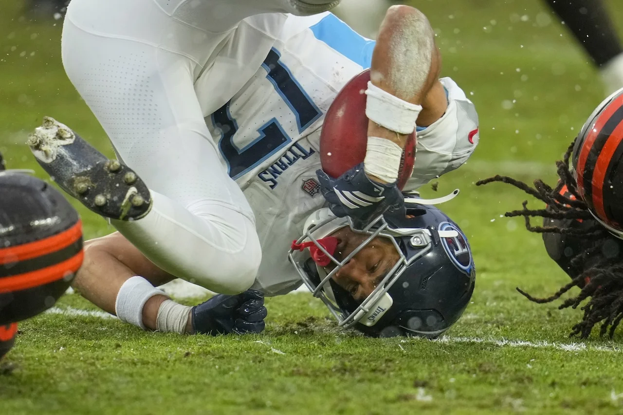 Tennessee Titans wide receiver Chimere Dike (17) rolls after a tackle in the second half of an NFL football game against the Cleveland Browns in Cleveland, Sunday, Dec. 7, 2025. (AP Photo/Sue Ogrocki)