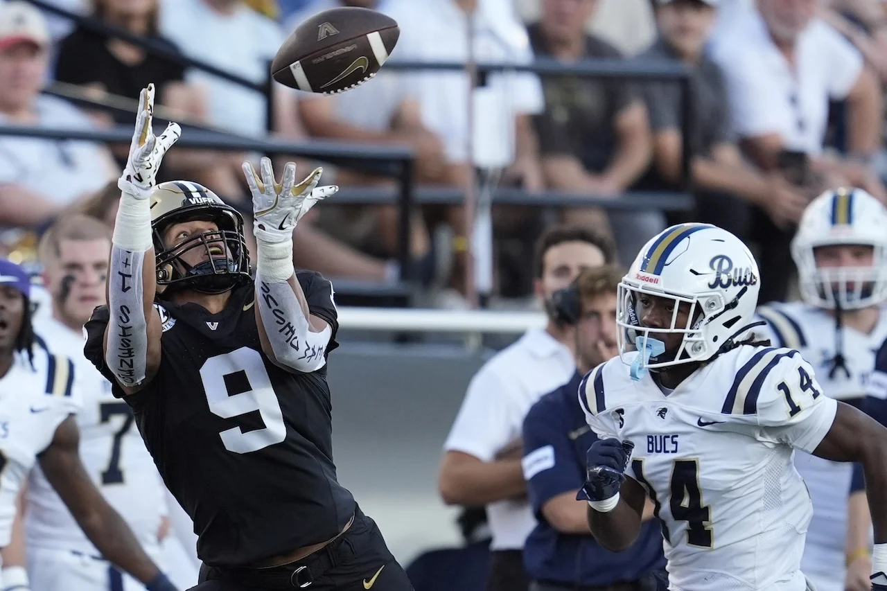 Vanderbilt tight end Eli Stowers (9) makes a catch past Charleston Southern safety Shamar Hall (14) during the first half of an NCAA college football game Saturday, Aug. 30, 2025, in Nashville, Tenn. (AP Photo/George Walker IV)