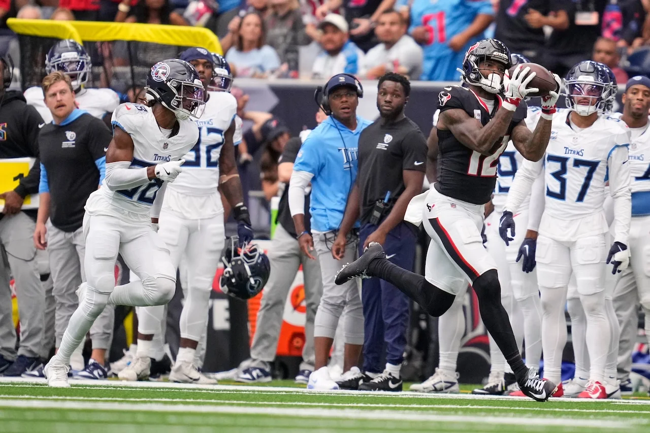 Houston Texans wide receiver Nico Collins, right, makes a catch past Tennessee Titans cornerback L'Jarius Sneed, left, during the second half of an NFL football game Sunday, Sept. 28, 2025, in Houston. (AP Photo/Ashley Landis)