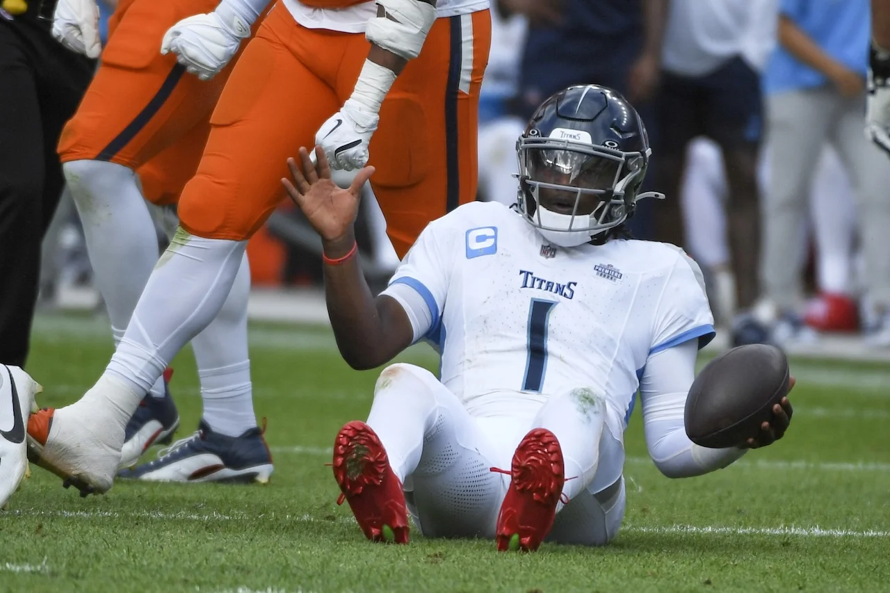 Tennessee Titans quarterback Cam Ward (1) sits on the grass after being sacked during the second half of an NFL football game against the Denver Broncos, Sunday, Sept. 7, 2025, in Denver. (AP Photo/Eric Lutzen)