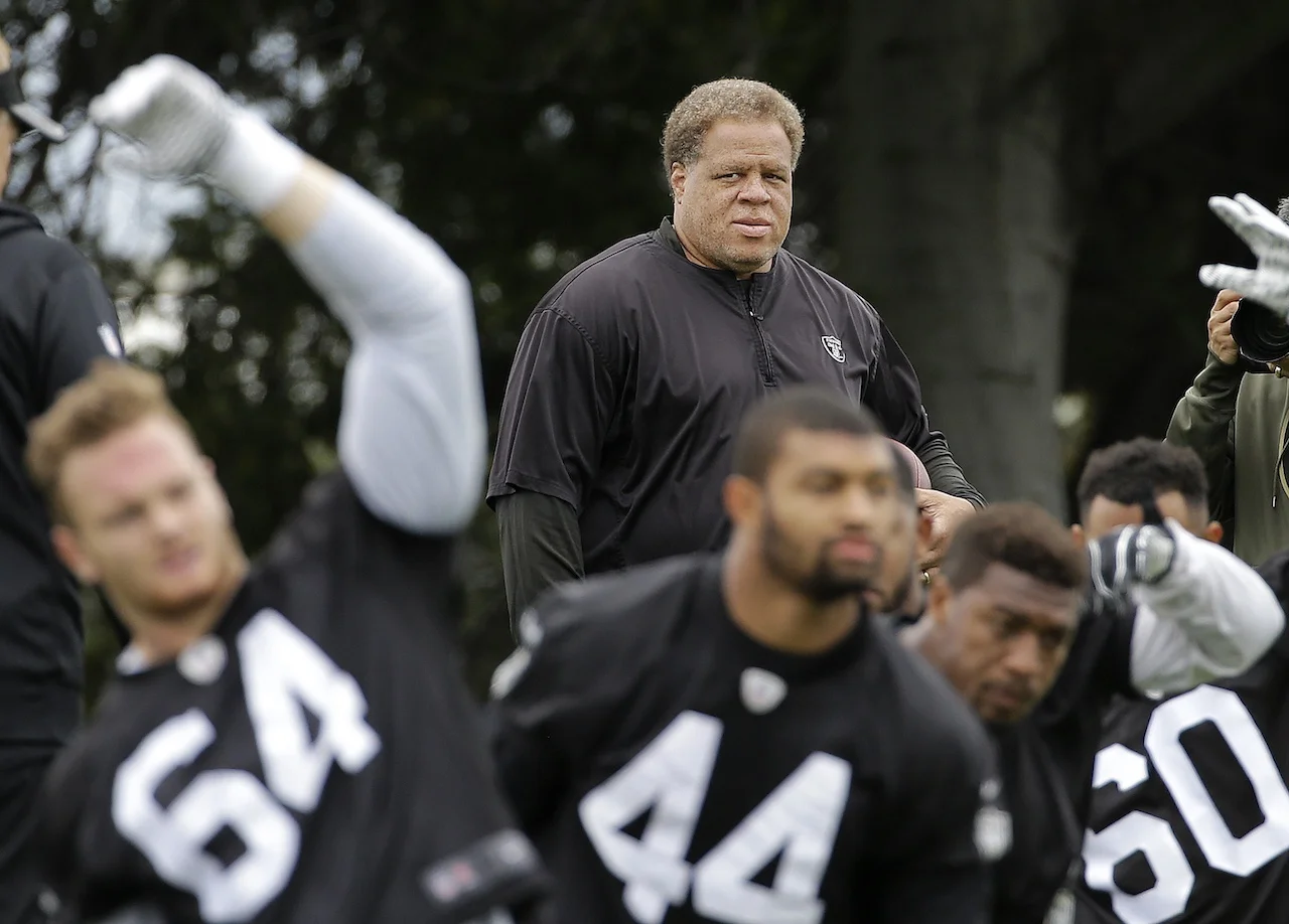 Oakland Raiders general manager Reggie McKenzie watches as players stretch during an NFL football rookie minicamp in Alameda, Calif., Friday, May 13, 2016. (AP Photo/Jeff Chiu)