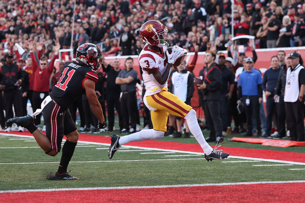 Oct 15, 2022; Salt Lake City, Utah, USA; USC Trojans wide receiver Jordan Addison (3) scores a touchdown against Utah Utes safety R.J. Hubert (11) in the first quarter at Rice-Eccles Stadium. Mandatory Credit: Rob Gray-USA TODAY Sports
