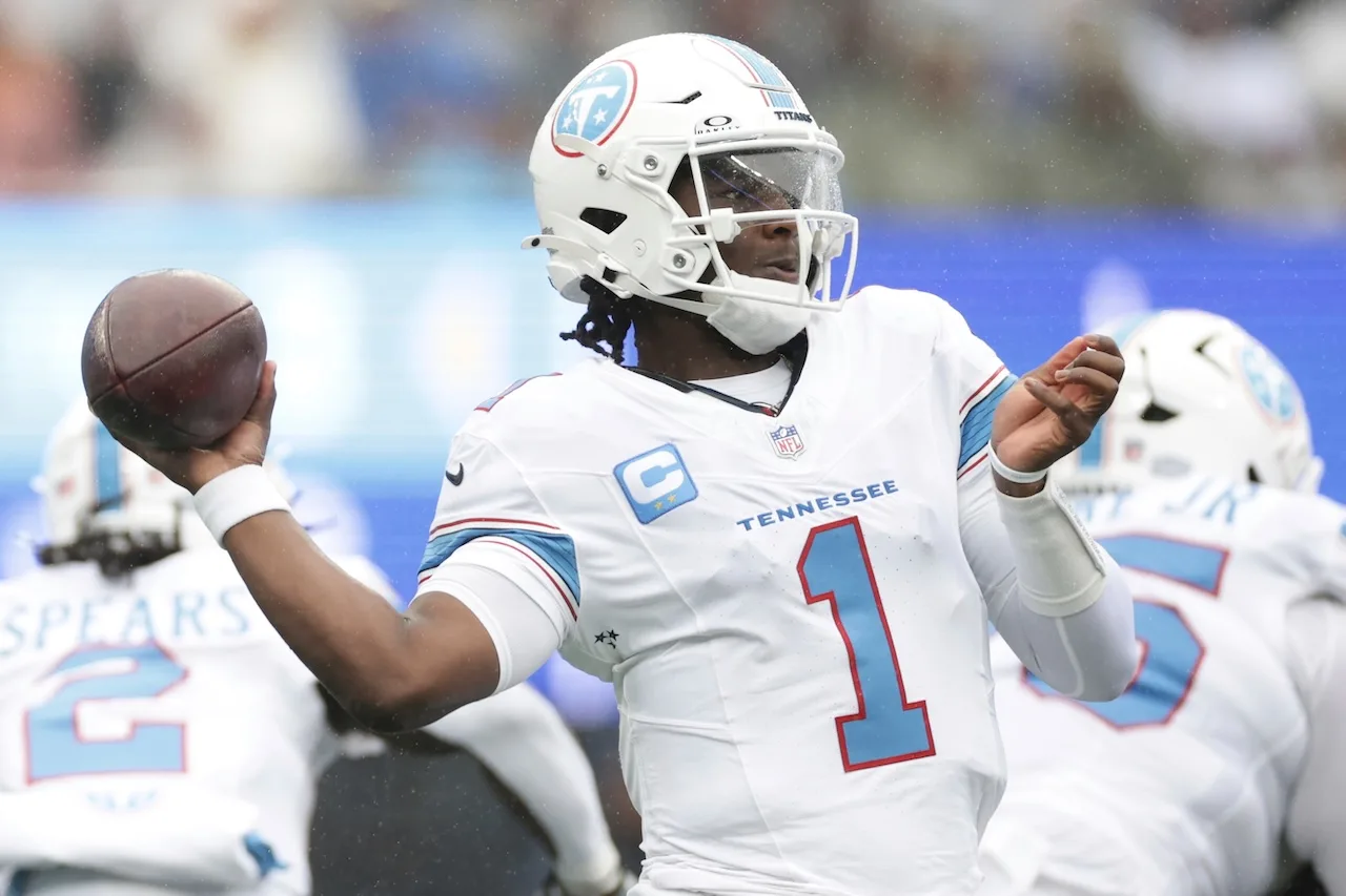 Tennessee Titans quarterback Cam Ward (1) looks to throw a pass during the first half of an NFL football game against the New York Giants in East Rutherford, N.J., Sunday, Sept. 27, 2026. (AP Photo/Adam Hunger)