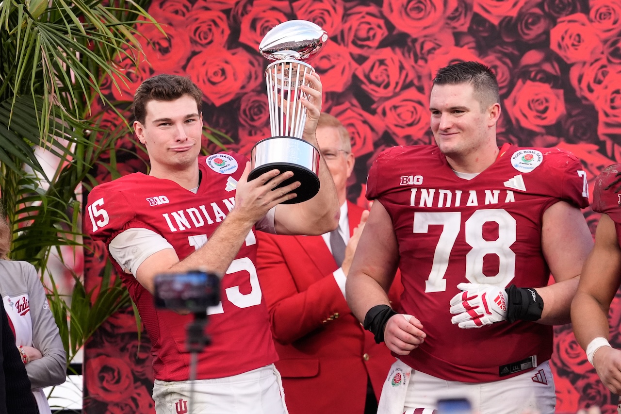 Indiana quarterback Fernando Mendoza (15) and offensive lineman Pat Coogan (78) celebrate after a win over Alabama in the Rose Bowl College Football Playoff quarterfinal game Thursday, Jan. 1, 2026, in Pasadena, Calif. (AP Photo/Mark J. Terrill)