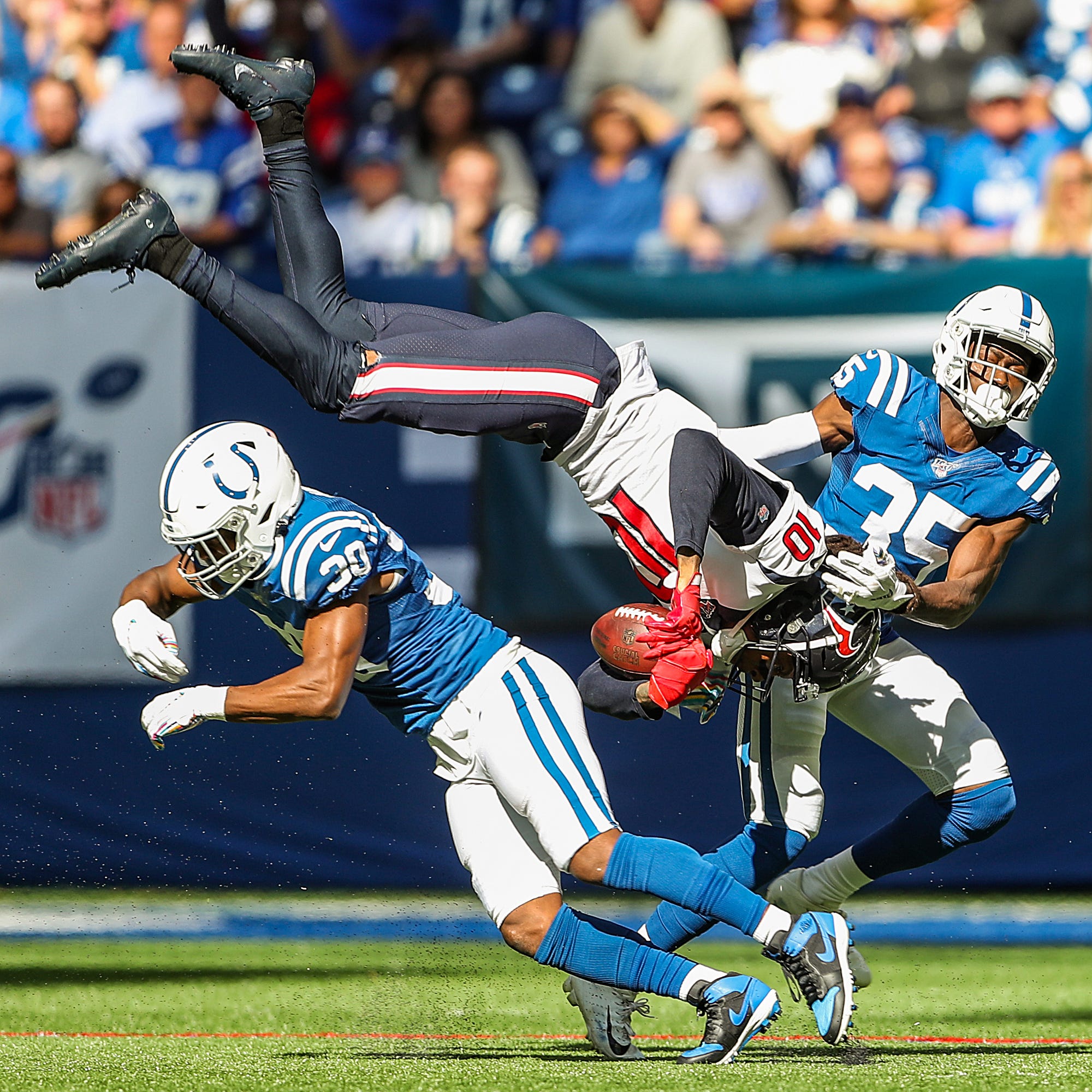 Houston Texans wide receiver DeAndre Hopkins (10) leaps between Indianapolis Colts defensive back George Odum (30) and cornerback Pierre Desir (35) during the second quarter of their game Lucas Oil Stadium in Indianapolis in NFL Week 7, Sunday, Oct. 20, 2019. Indystar Staff Photographer Jenna Watson Best Photos Of The Year 2019