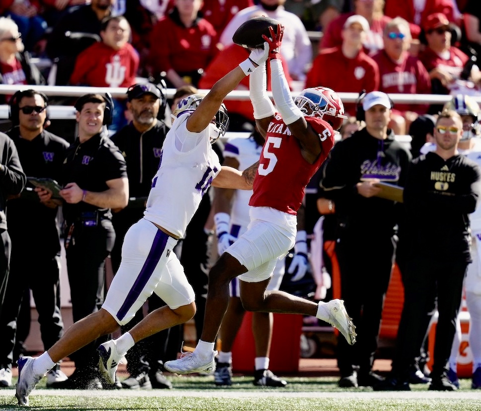 Indiana defensive back D'Angelo Ponds (5) makes an interception against Washington wide receiver Denzel Boston (12) during the first half of an NCAA college football game, Saturday, Oct. 26, 2024, in Bloomington, Ind. (AP Photo/Darron Cummings)