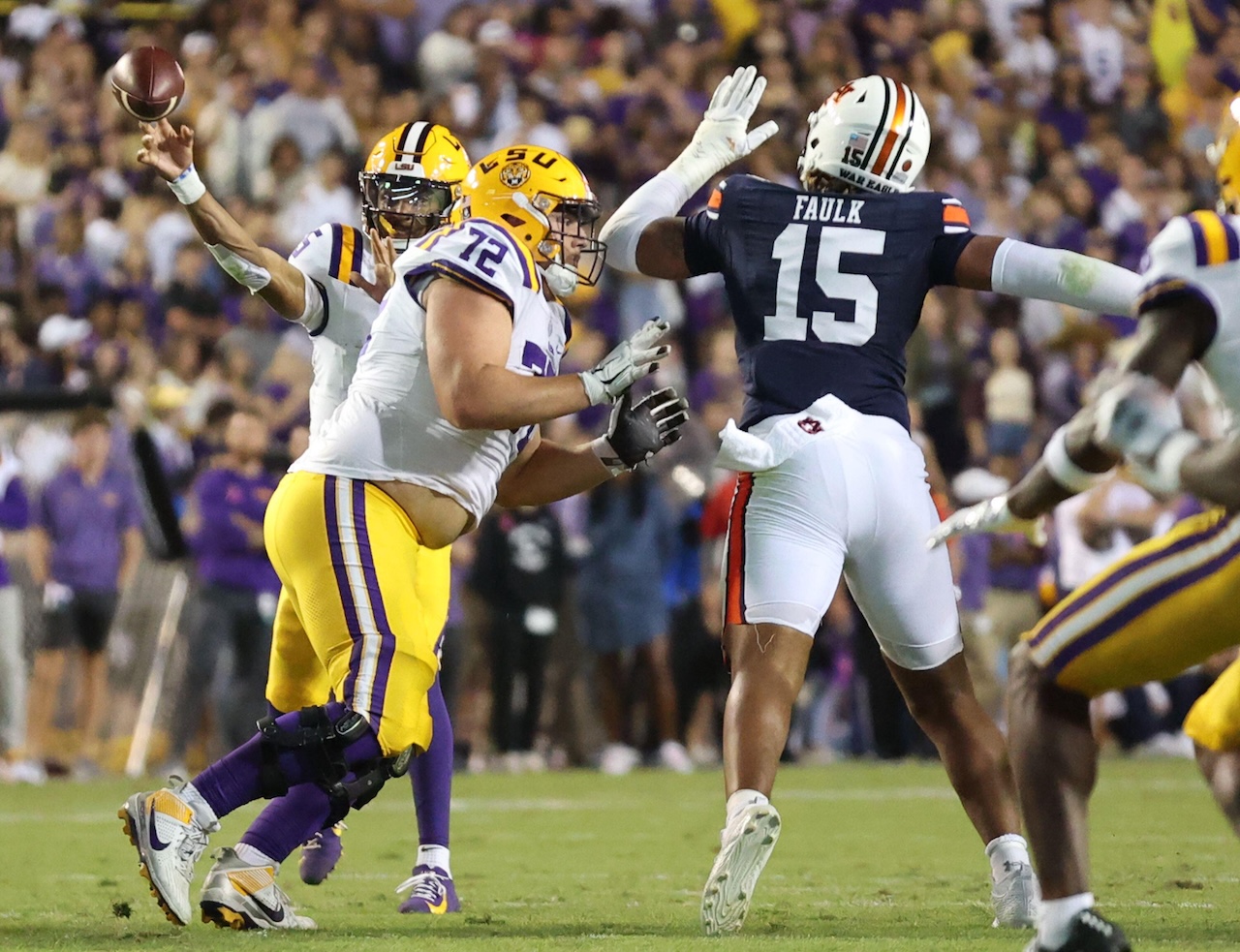 LSU Tigers quarterback Jayden Daniels (5) attempts a pass while offensive lineman Garrett Dellinger (72) blocks Auburn Tigers defensive lineman Keldric Faulk (15) during a Southeastern Conference football game at Tiger Stadium in Baton Rouge, Louisiana on Saturday, October 14, 2023. (Photo by Peter G. Forest/Sipa USA)
