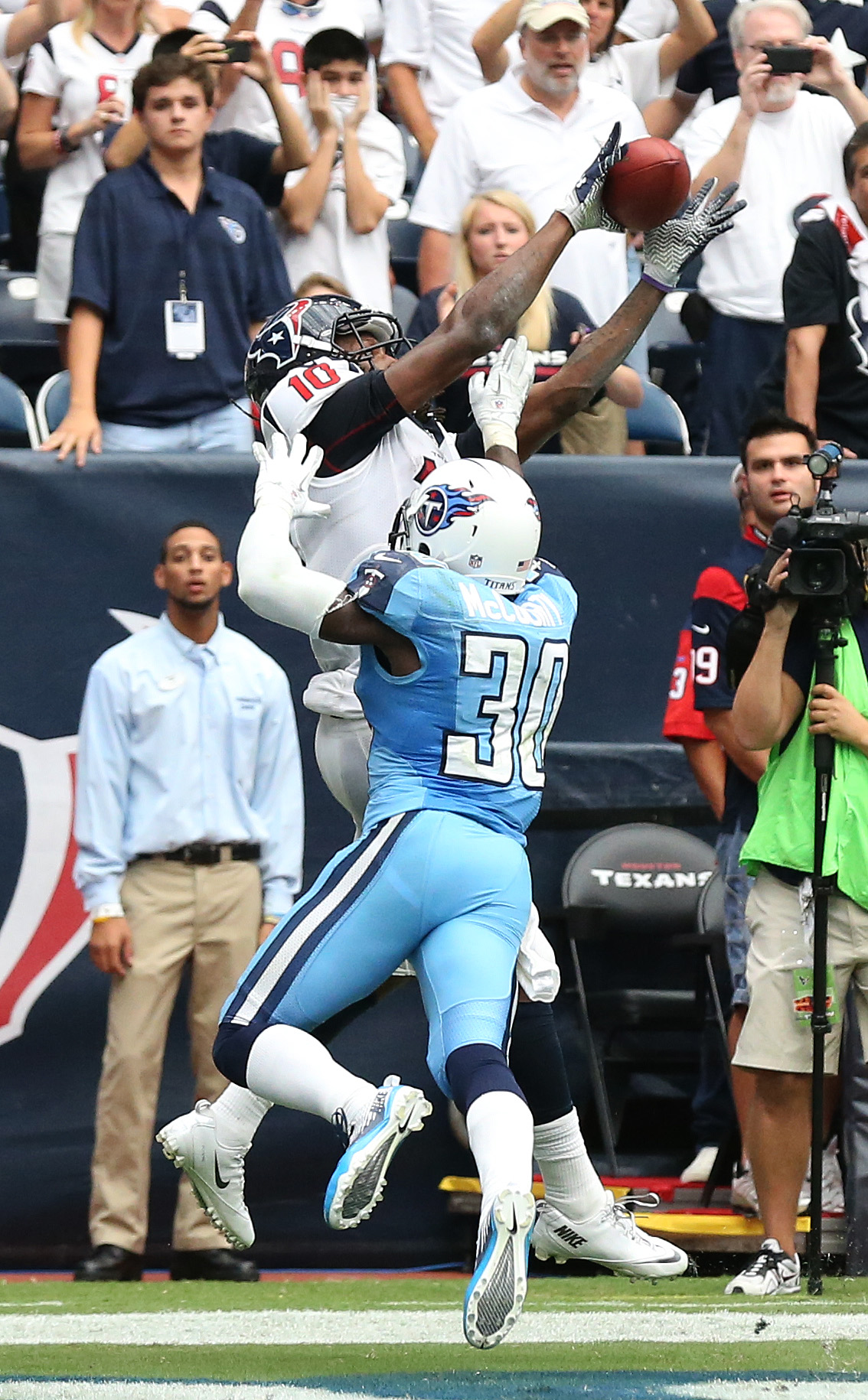 Sep 15, 2013; Houston, TX, USA; Houston Texans receiver DeAndre Hopkins (10) catches a touchdown pass in overtime against Tennessee Titans cornerback Jason McCourty (30) at Reliant Stadium. The Houston Texans beat the Tennessee Titans 30-24 in overtime.