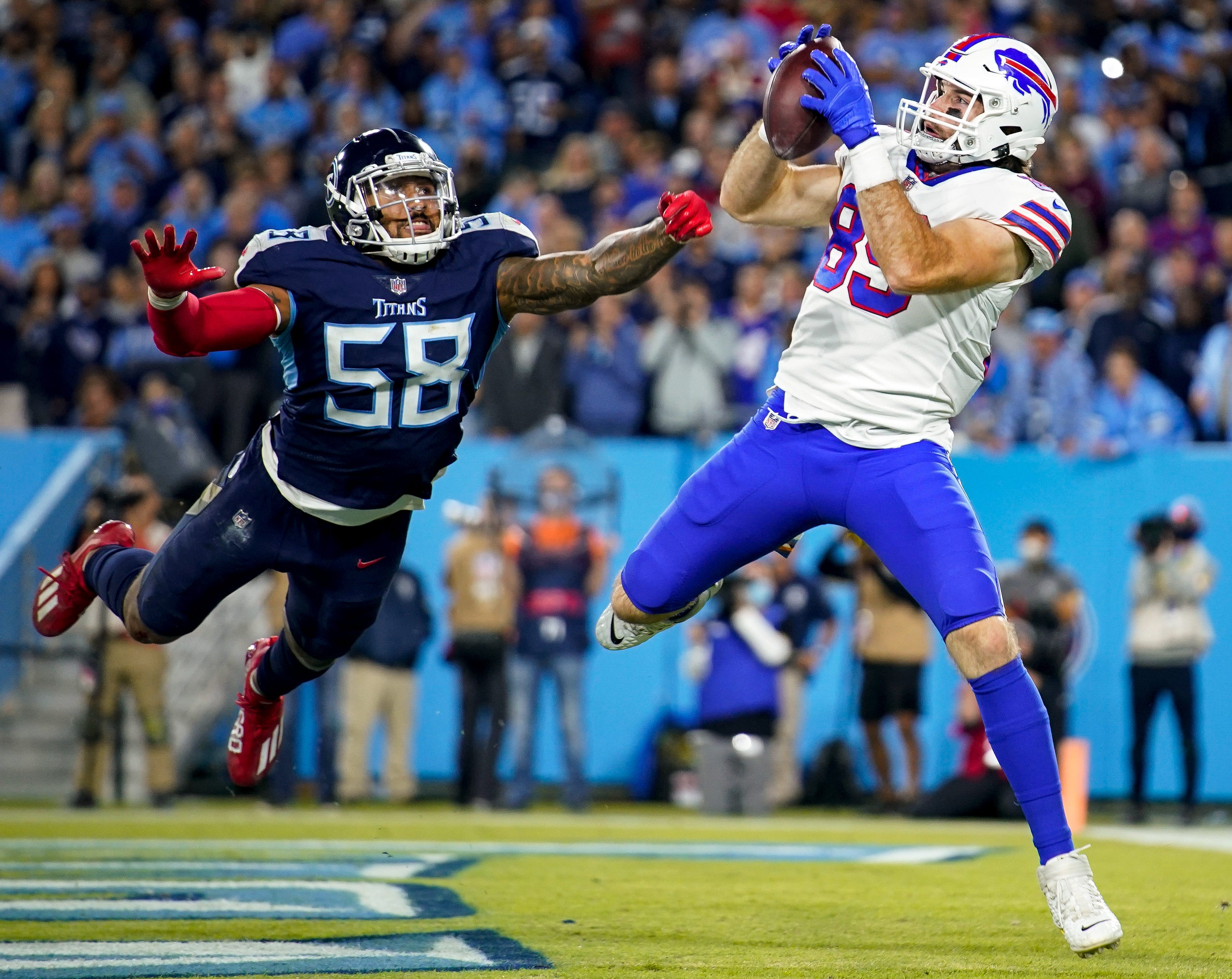 Buffalo Bills tight end Tommy Sweeney (89) scores a touchdown past Tennessee Titans linebacker Harold Landry III (58) during the third quarter at Nissan Stadium in Nashville, Tenn., Monday, Oct. 18, 2021. Nelles Poy