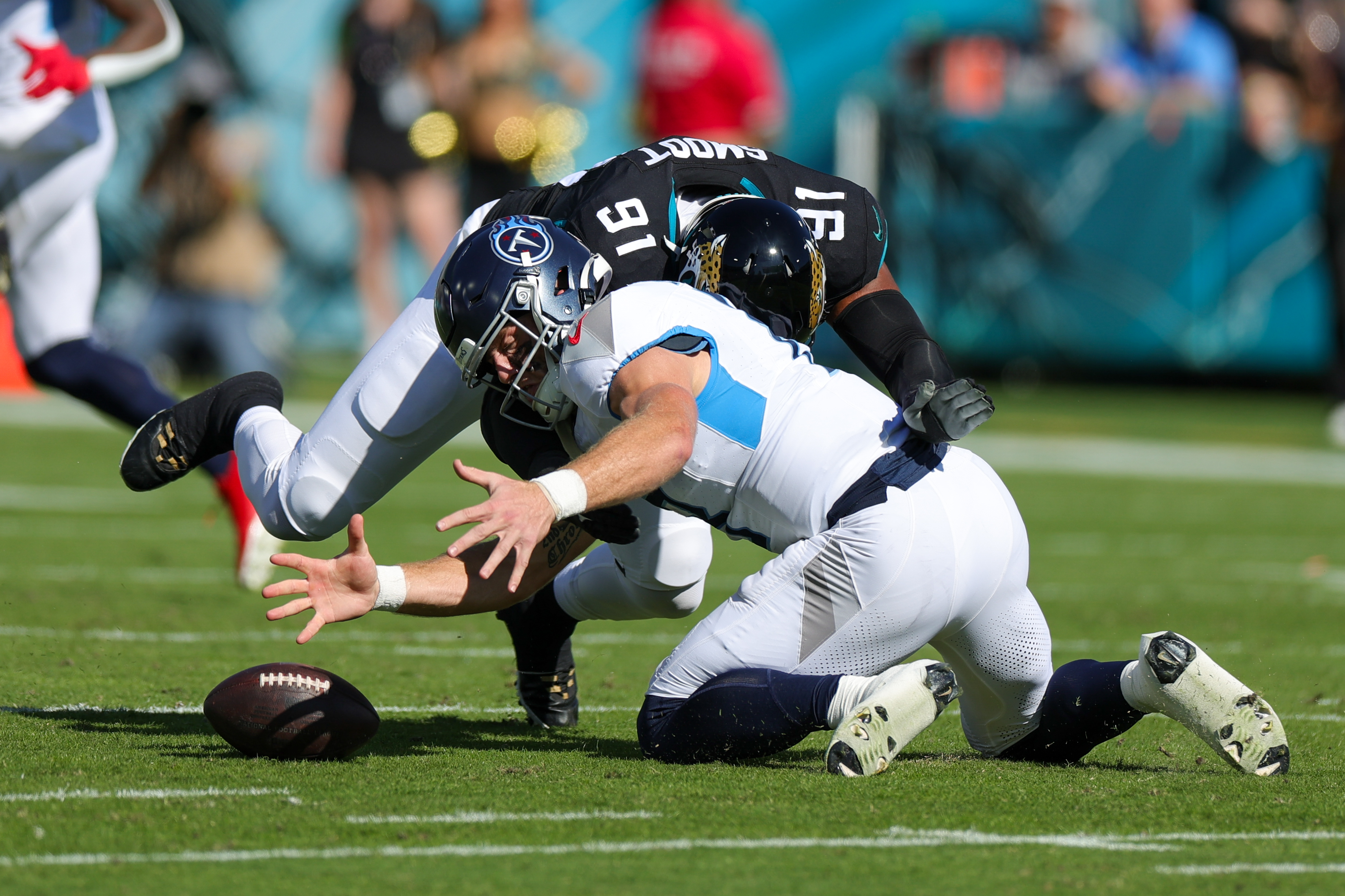 Nov 19, 2023; Jacksonville, Florida, USA; Tennessee Titans quarterback Will Levis (8) fumbles the ball pressured by Jacksonville Jaguars linebacker Dawuane Smoot (91) in the first quarter at EverBank Stadium. Mandatory Credit: Nathan Ray Seebeck-USA TODAY Sports