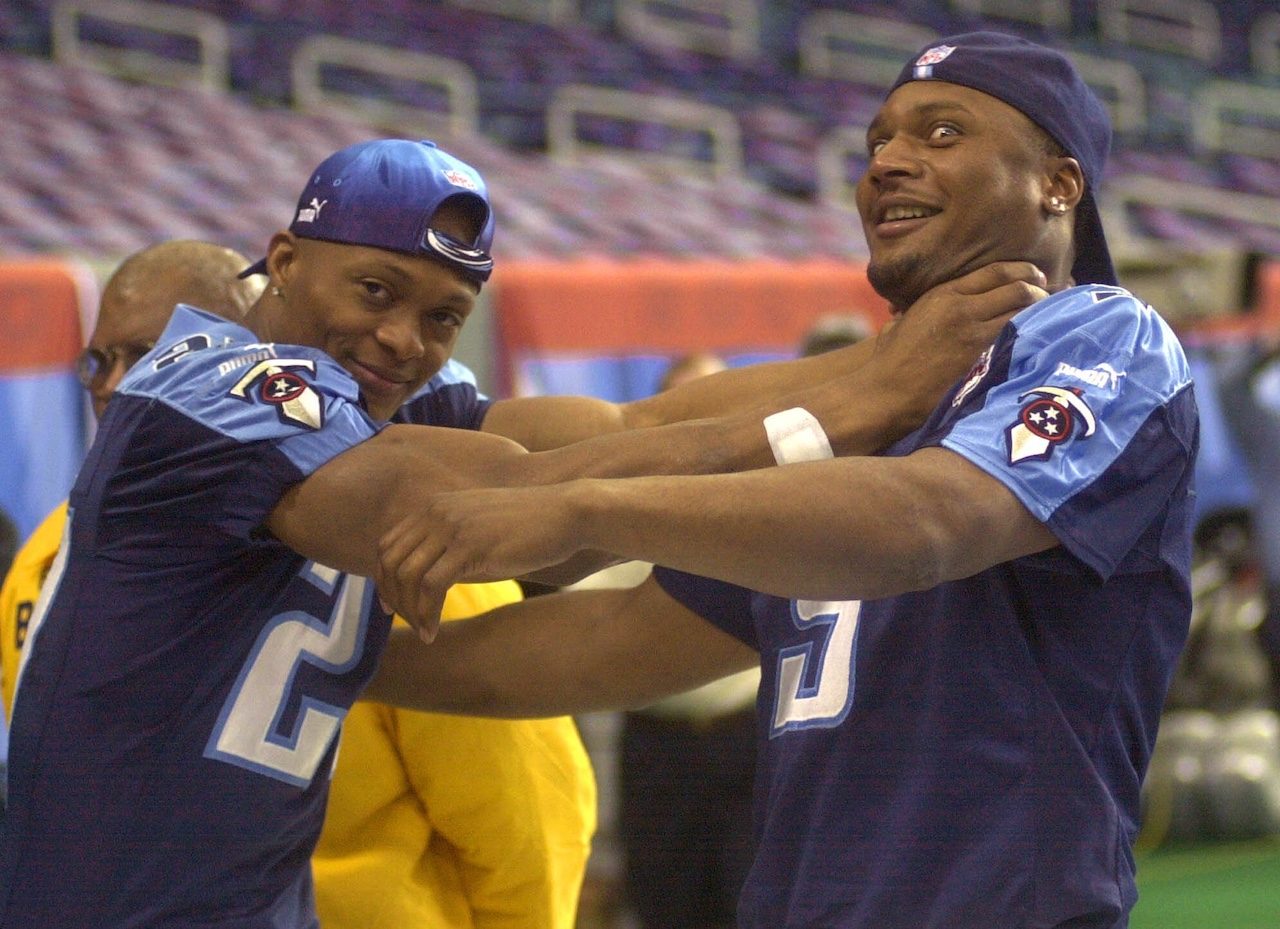 Tennessee Titans running back Eddie George, left, playfully "chokes" Titans quarterback Steve McNair during Super Bowl XXXIV Media Day activities at the Georgia Dome in Atlanta Tuesday, Jan. 25, 2000. (AP Photo/John Bazemore)