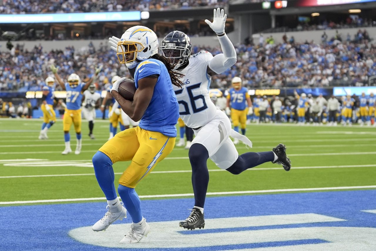 Los Angeles Chargers wide receiver Quentin Johnston (1) makes a catch for a touchdown past Tennessee Titans linebacker Kenneth Murray Jr. (56) during the second half of an NFL football game Sunday, Nov. 10, 2024, in Inglewood, Calif. (AP Photo/Gregory Bull)