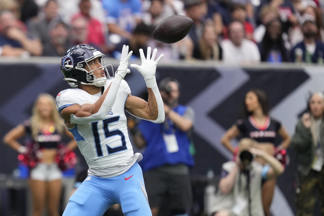 Tennessee Titans wide receiver Nick Westbrook-Ikhine (15) catches a pass for a touchdown during the first half of an NFL football game against the Houston Texans, Sunday, Nov. 24, 2024, in Houston. (AP Photo/Eric Christian Smith)