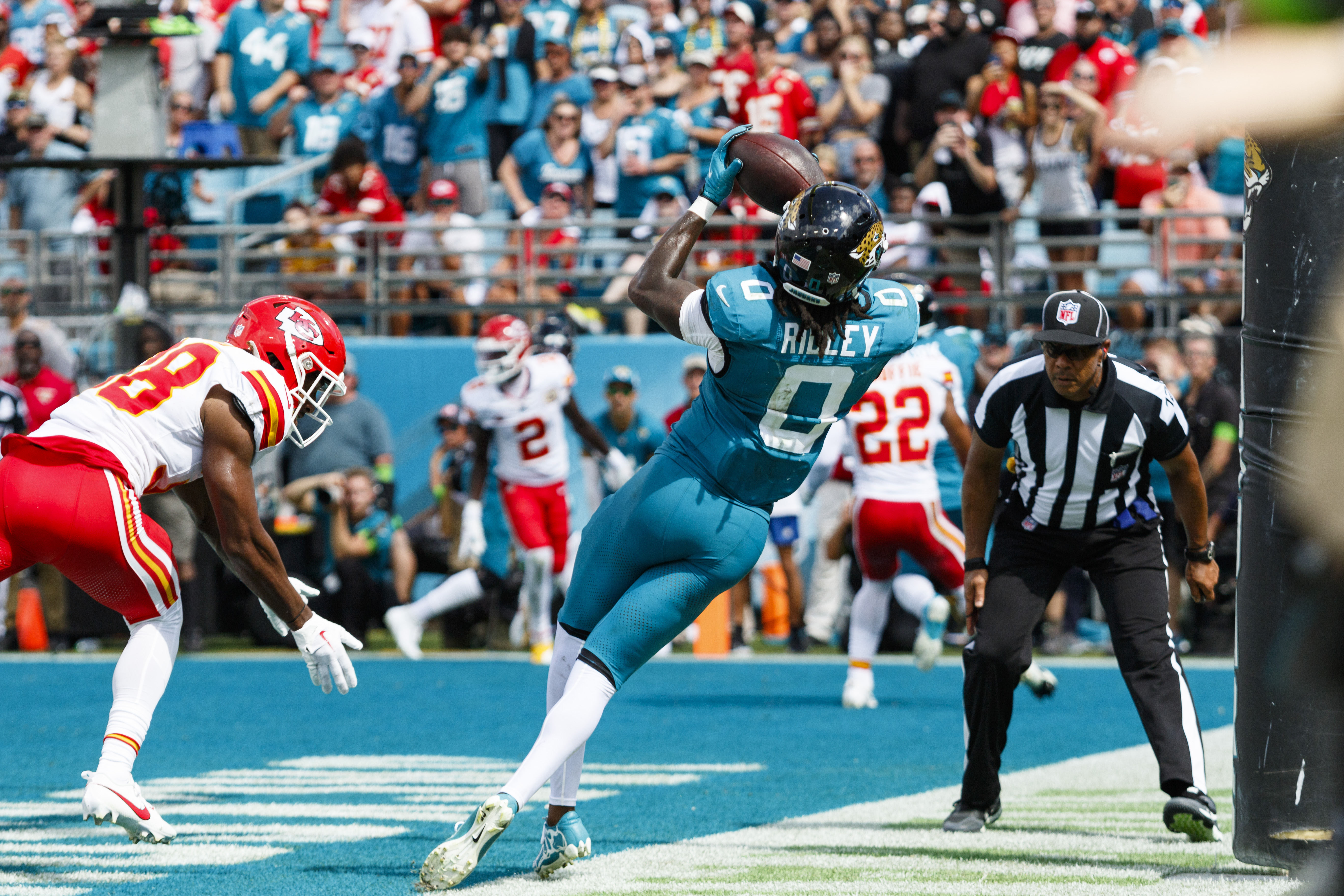 Sep 17, 2023; Jacksonville, Florida, USA; Jacksonville Jaguars wide receiver Calvin Ridley (0) catches a ball just outside of the endzone with pressure from Kansas City Chiefs corner back L'Jarius Sneed (38) during the fourth quarter at EverBank Stadium. Mandatory Credit: Morgan Tencza-USA TODAY Sports