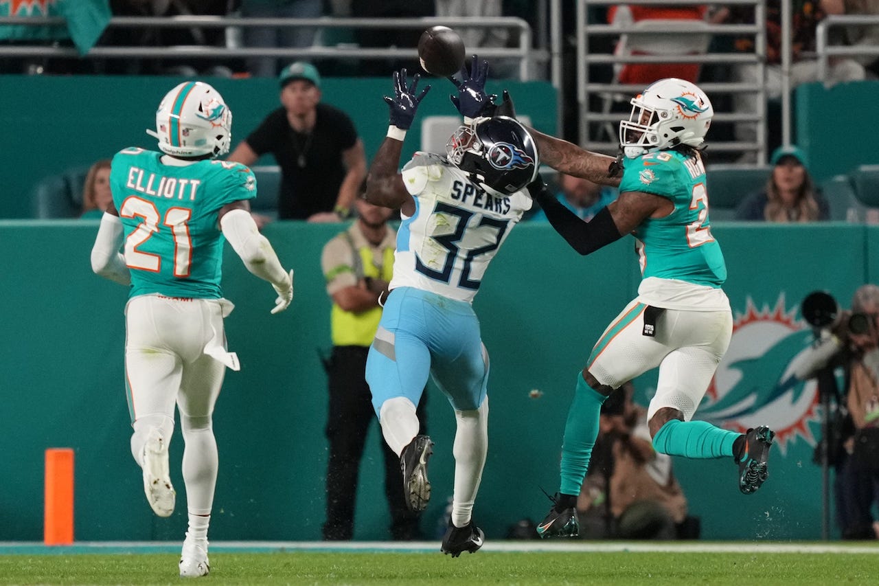 Tennessee Titans running back Tyjae Spears (32) catches a pass over Miami Dolphins linebacker Bradley Chubb (2) during the second half of an NFL game at Hard Rock Stadium in Miami Gardens, Dec. 11, 2023.