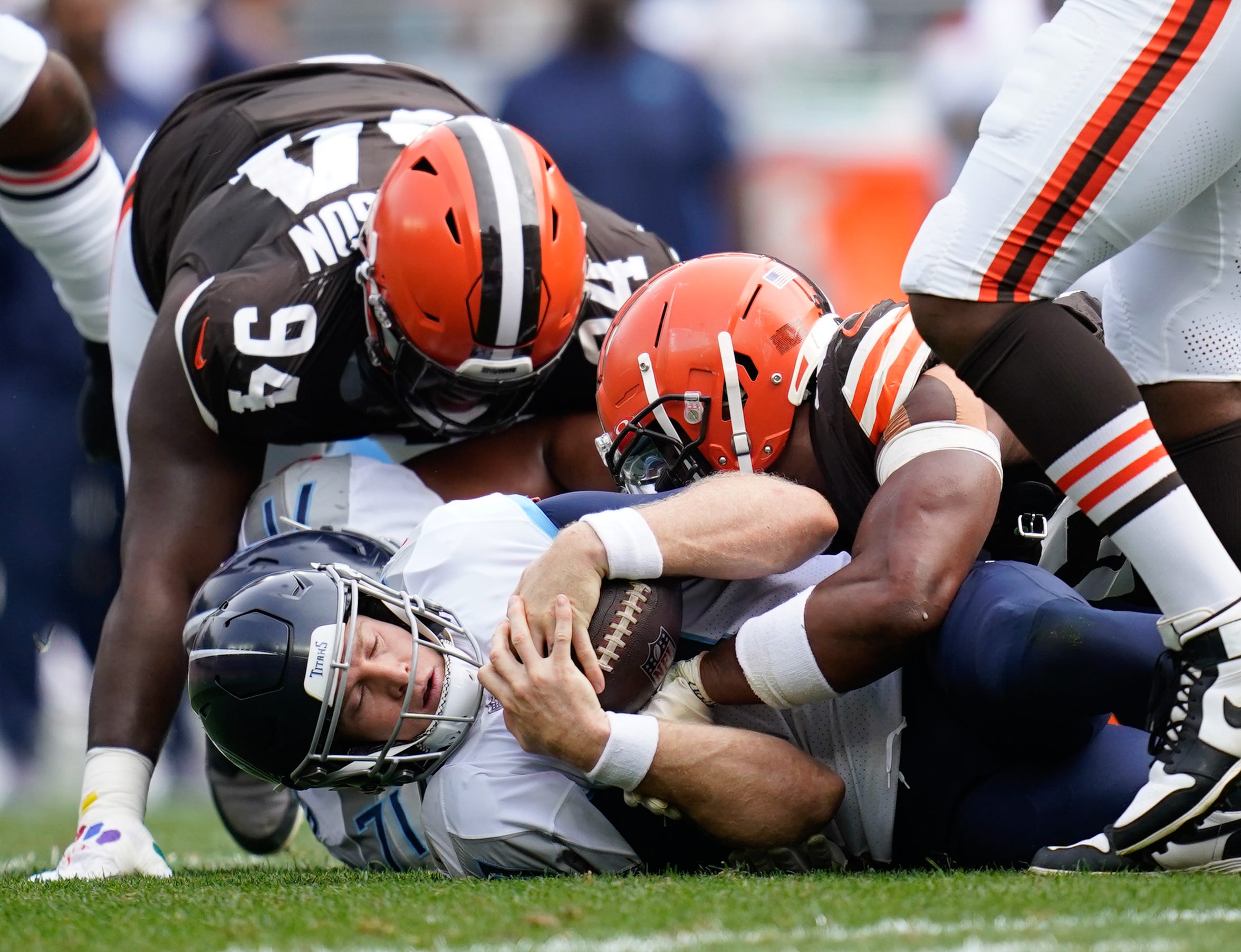 Tennessee Titans quarterback Ryan Tannehill (17) gets sacked at the end of the first half in Cleveland, Ohio, Sunday, Sept. 24, 2023.