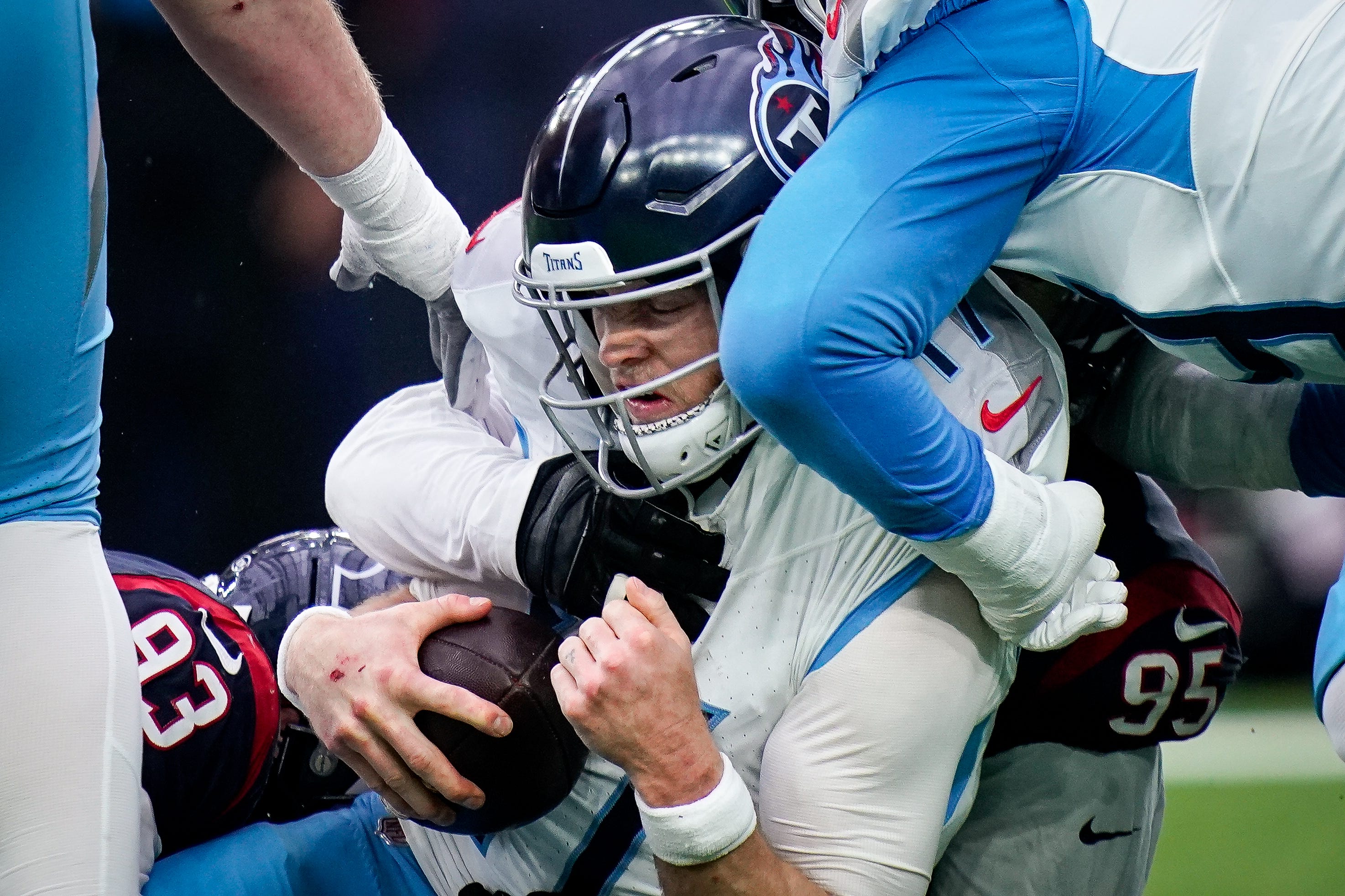 Tennessee Titans quarterback Ryan Tannehill (17) is sacked by Houston Texans defensive tackle Kurt Hinish (93) and defensive end Derek Barnett (95) during the fourth quarter at NRG Stadium in Houston, Texas., Sunday, Dec. 31, 2023.
