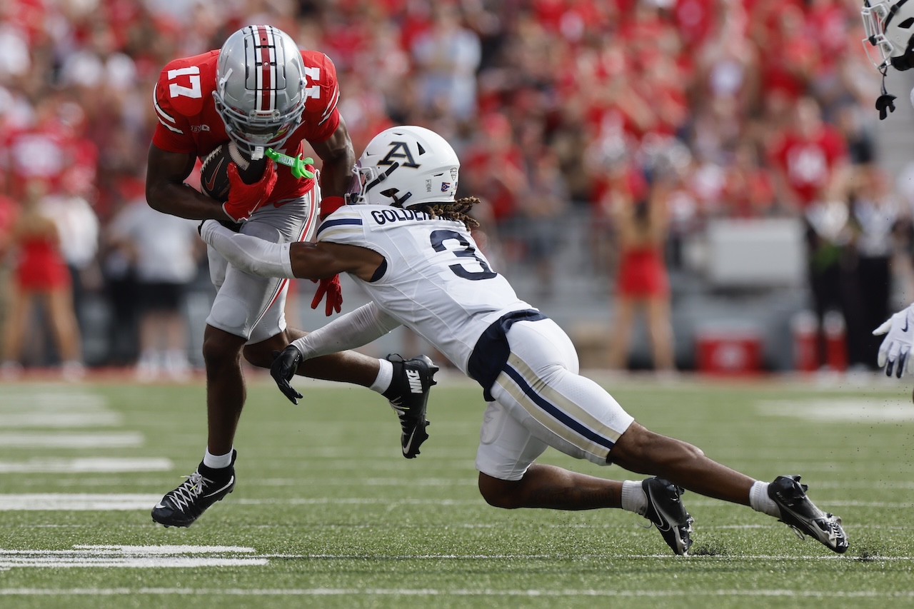 Akron defensive back Devonte Golden-Nelson, right, tackles Ohio State receiver Carnell Tate during the first half of an NCAA college football game Saturday, Aug. 31, 2024, in Columbus, Ohio. (AP Photo/Jay LaPrete)