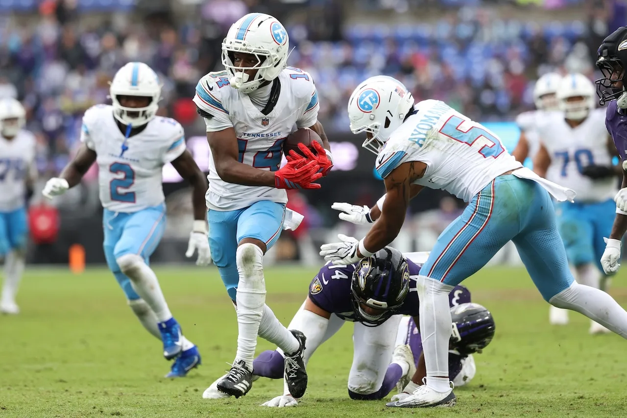 Tennessee Titans wide receiver Carnell Tate (14) runs with the ball after catching a pass during the second half of an NFL football game against the Baltimore Ravens in Baltimore, Sunday, Oct. 4, 2026. (AP Photo/Terrance Williams)