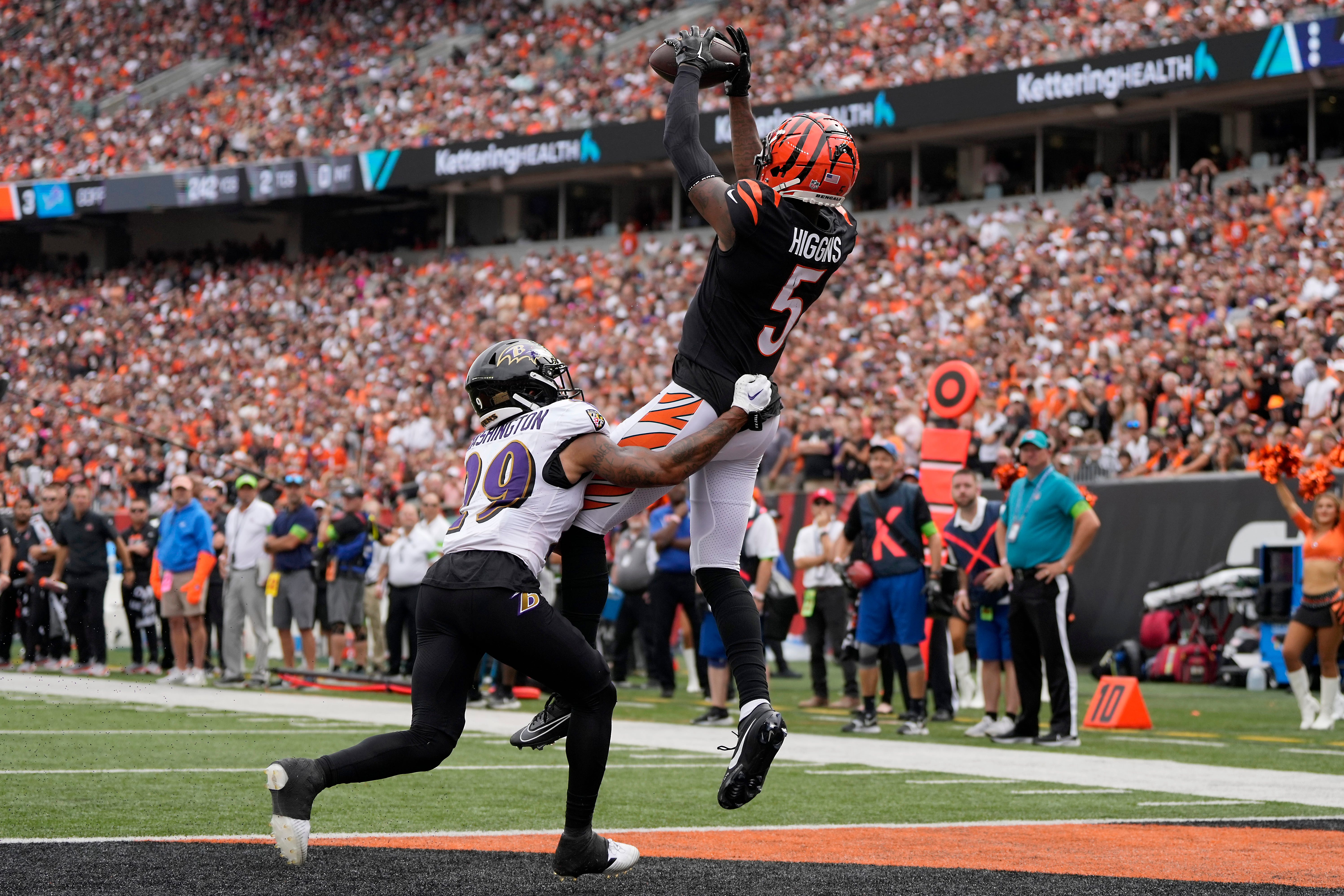 Cincinnati Bengals wide receiver Tee Higgins (5) catches a touchdown as Baltimore Ravens safety Ar'Darius Washington (29) defends in the third quarter of a Week 2 NFL football game between the Baltimore Ravens and the Cincinnati Bengals Sunday, Sept. 17, 2023, at Paycor Stadium in Cincinnati.