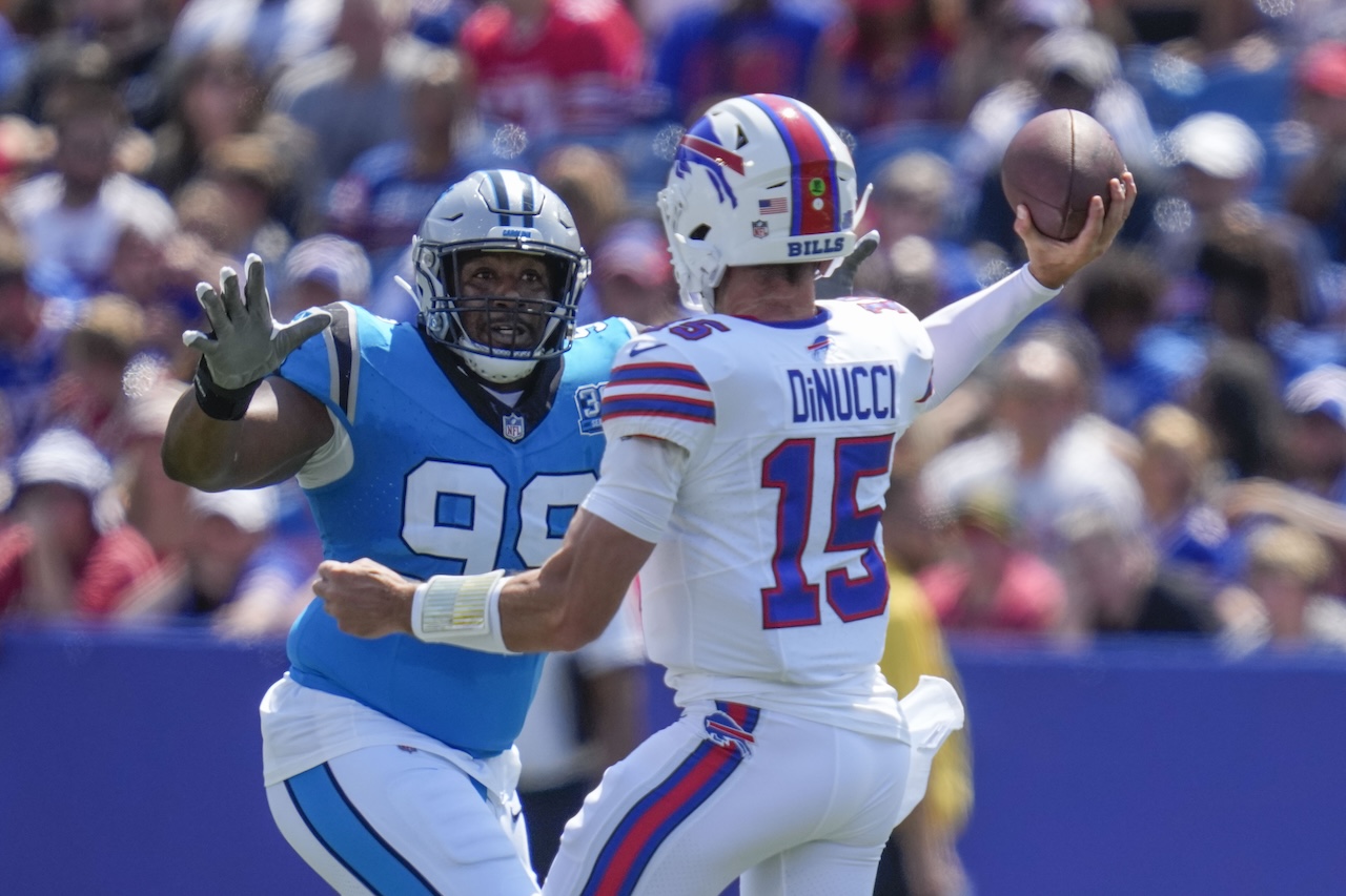 Carolina Panthers wide receiver Jonathan Mingo (15) passes under pressure from Carolina Panthers defensive tackle Shy Tuttle (99) in the first half of an NFL preseason football game, Saturday, Aug. 24, 2024, in Orchard Park, N.Y. (AP Photo/Charles Krupa)
