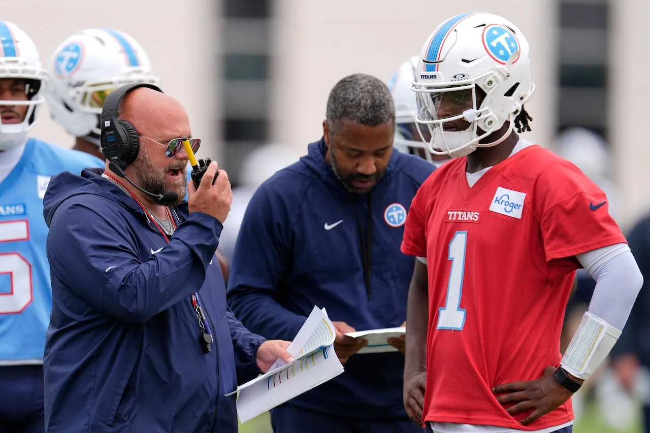 Tennessee Titans offensive coordinator Brian Daboll, right, uses a radio with quarterback Cam Ward (1) during an NFL football practice Tuesday, June 9, 2026, in Nashville, Tenn. (AP Photo/George Walker IV)