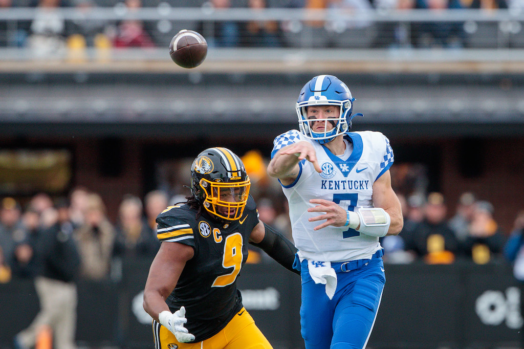 Nov 5, 2022; Columbia, Missouri, USA; Kentucky Wildcats quarterback Will Levis (7) passes before being hit by Missouri Tigers defensive lineman Isaiah McGuire (9) during the first quarter at Faurot Field at Memorial Stadium. 