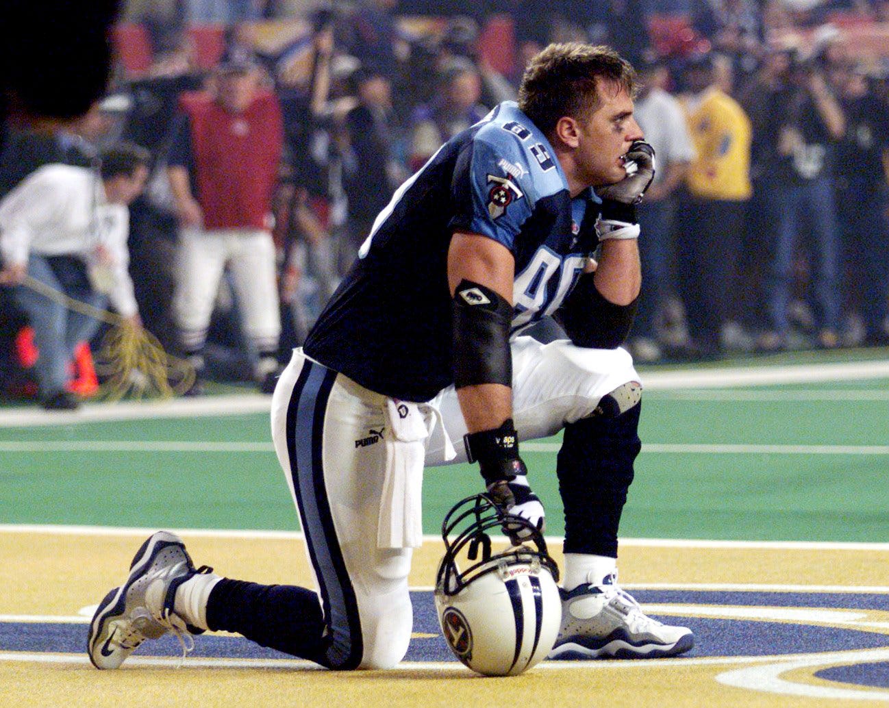 A dejected Frank Wycheck of the Tennessee Titans stares out from the end zone as the St. Louis Rams celebrate their Super Bowl XXXIV victory in Atlanta Jan. 30, 2000. Super Bowl