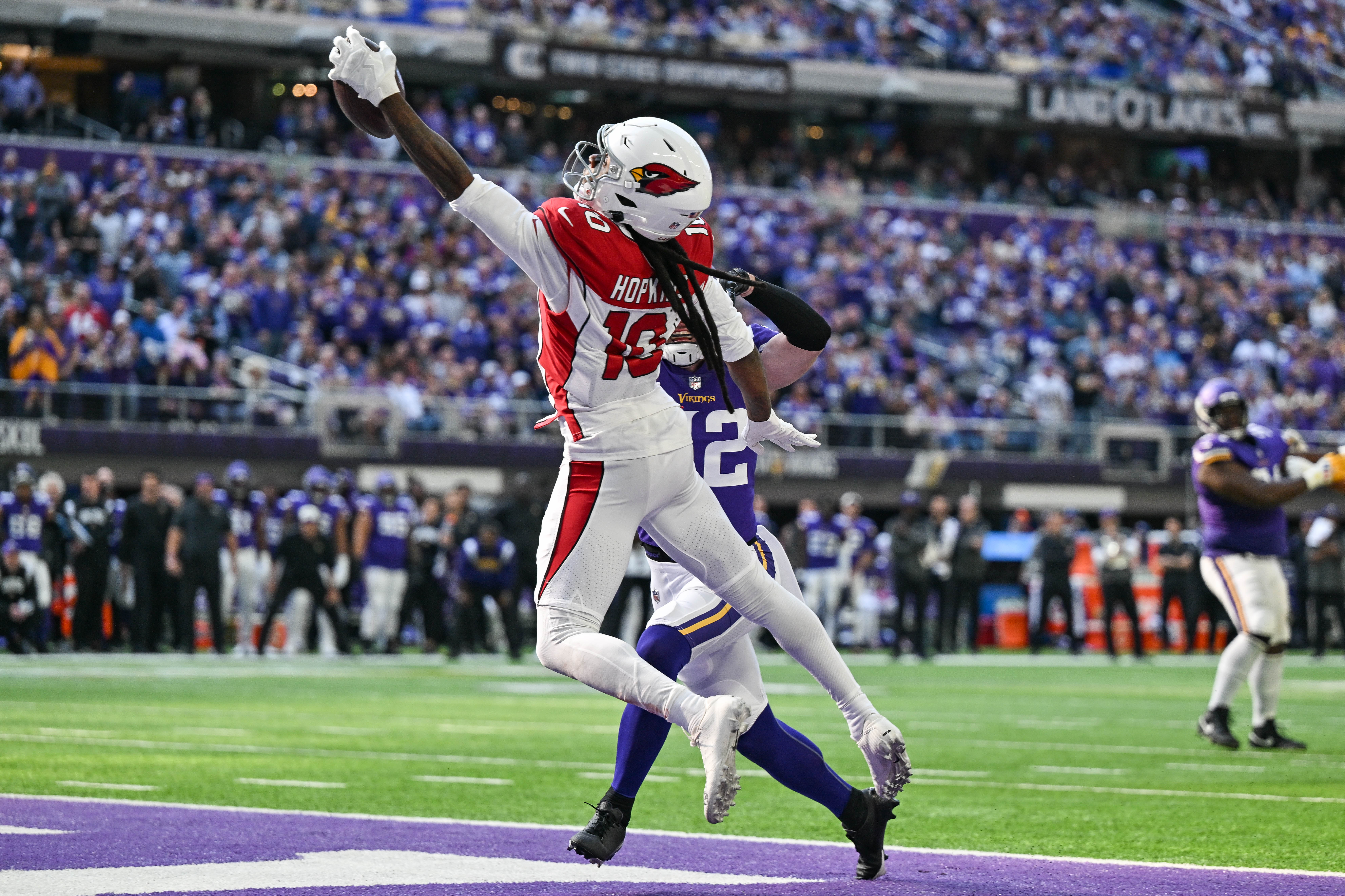 Oct 30, 2022; Minneapolis, Minnesota, USA; Arizona Cardinals wide receiver DeAndre Hopkins (10) catches a touchdown pass from quarterback Kyler Murray (not pictured) as Minnesota Vikings safety Harrison Smith (22) defends during the second quarter at U.S. Bank Stadium. Mandatory Credit: Jeffrey Becker-USA TODAY Sports
