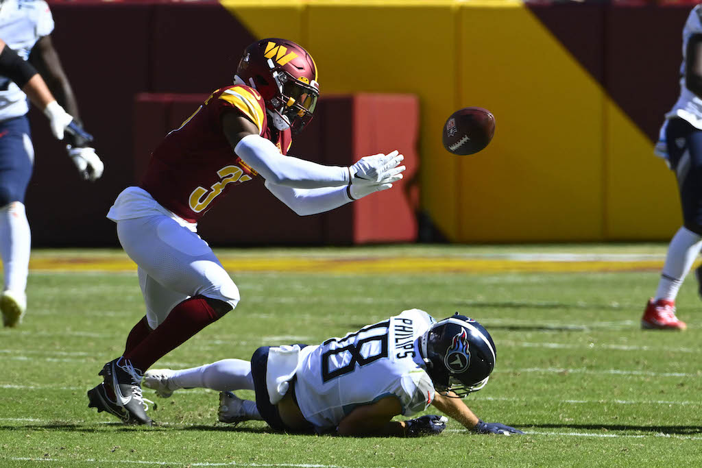 Oct 9, 2022; Landover, Maryland, USA; Washington Commanders cornerback Rachad Wildgoose (37) breaks up a pass for Tennessee Titans wide receiver Kyle Philips (18) during the first half at FedExField.