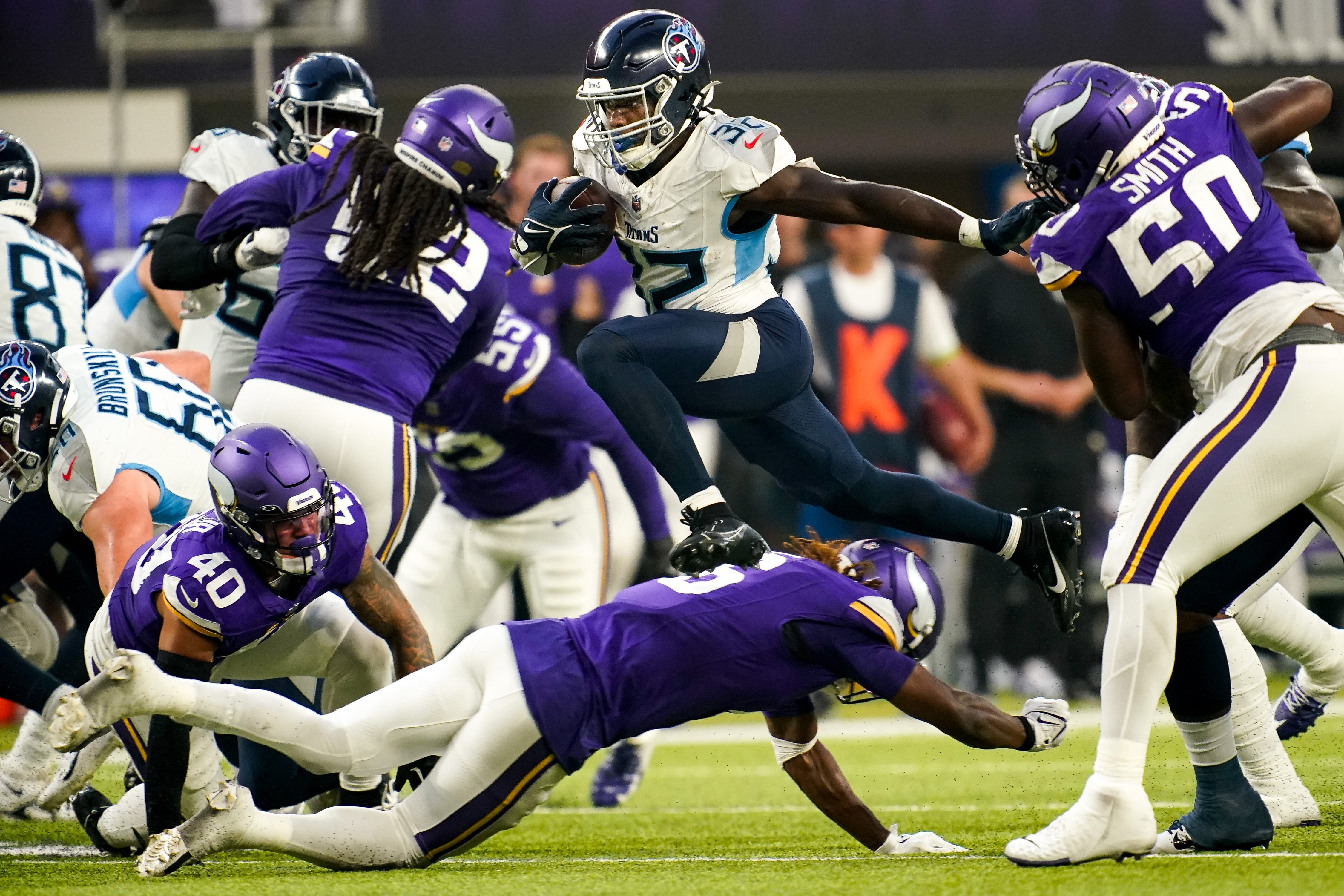 Tennessee Titans running back Tyjae Spears (32) leaps over the Minnesota Vikings defense to score a touchdown during the first quarter at U.S. Bank Stadium in Minneapolis, Minn., Saturday, Aug. 19, 2023.